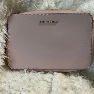 A small Michael Kors cross body purse. Never used